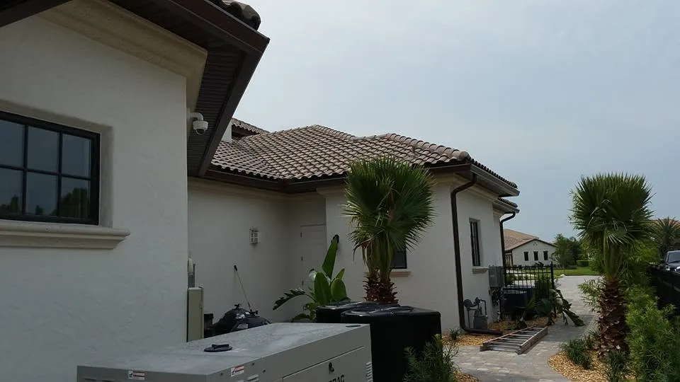 Brown gutters white stucco home barrel tile roof generator palms, Lake Mary